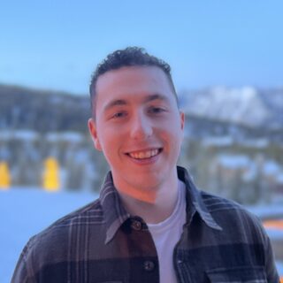 Jacob, smiling outside in the mountains